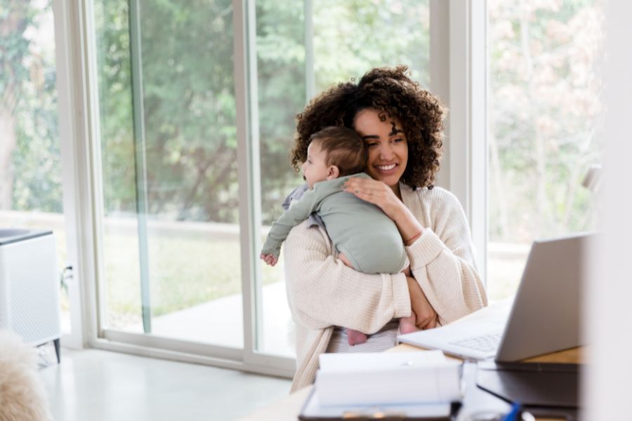 Mompreneur working at home while carrying her child